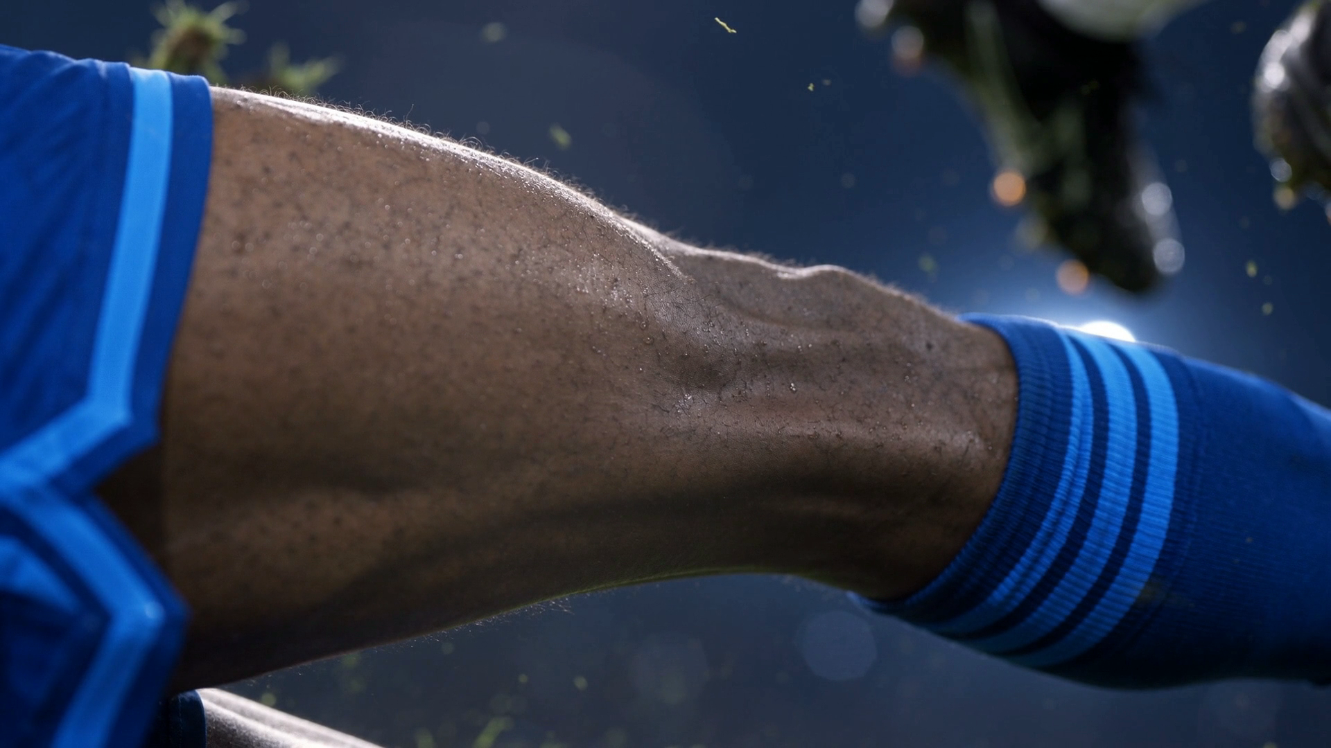 Close on the back of the defender's right thigh under the floodlights